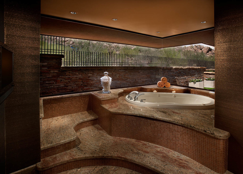 Example of a transitional master brown tile and mosaic tile brown floor drop-in bathtub design in Phoenix with brown walls