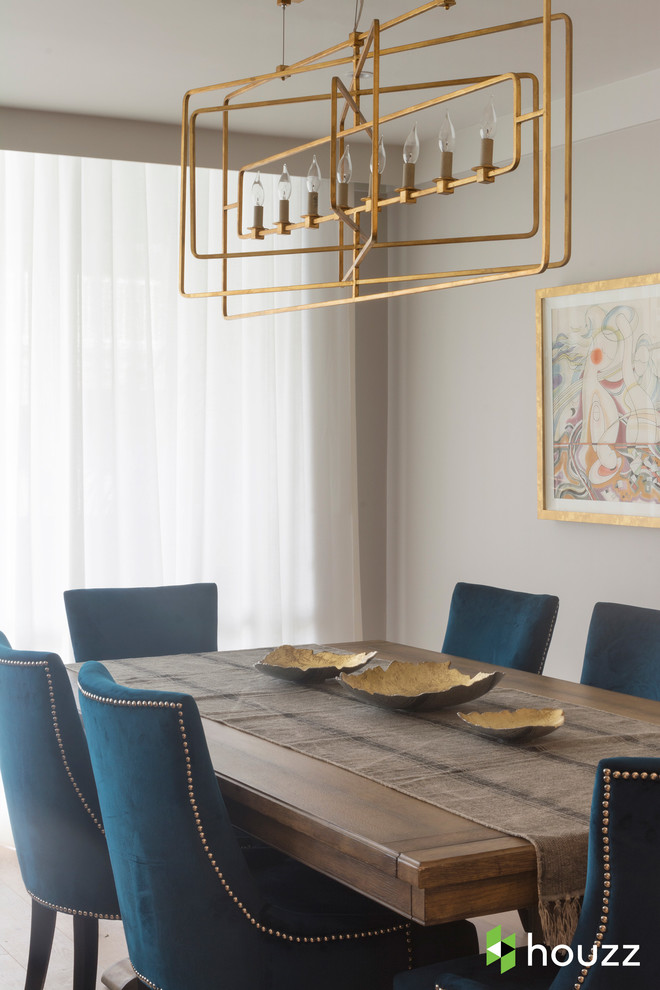 This is an example of a transitional dining room in Los Angeles with grey walls.