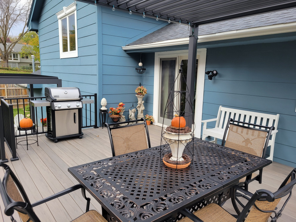 Inspiration for a large backyard ground level metal railing deck remodel with a pergola