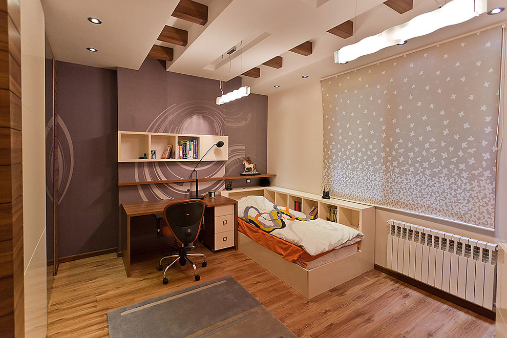 This is an example of a contemporary gender-neutral kids' bedroom for kids 4-10 years old in Other with medium hardwood floors and multi-coloured walls.