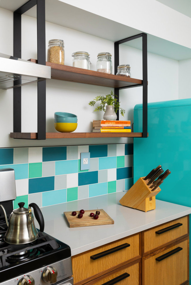 Inspiration for a mid-sized midcentury galley eat-in kitchen in Denver with an undermount sink, flat-panel cabinets, medium wood cabinets, quartz benchtops, multi-coloured splashback, ceramic splashback, coloured appliances, porcelain floors, grey floor and white benchtop.