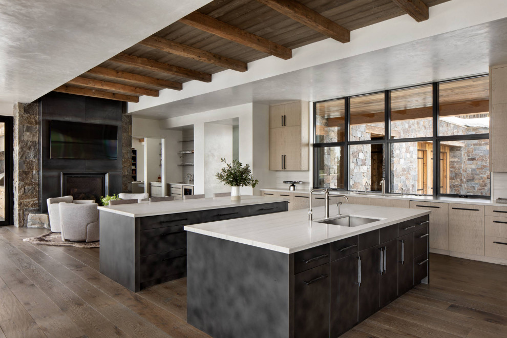 Inspiration for a rustic exposed beam and dark wood floor kitchen remodel with two islands, white countertops, a drop-in sink and flat-panel cabinets