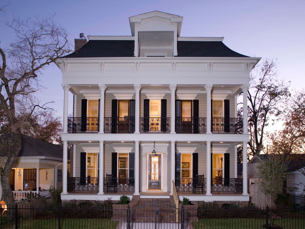 This is an example of a mid-sized traditional two-storey exterior in Houston.