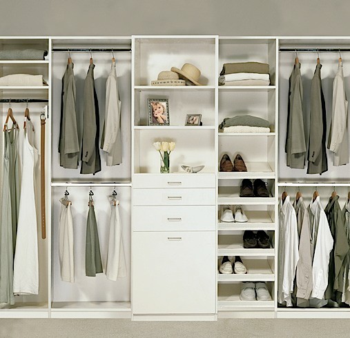 Design ideas for a mid-sized traditional gender-neutral walk-in wardrobe in Los Angeles with flat-panel cabinets, white cabinets and carpet.