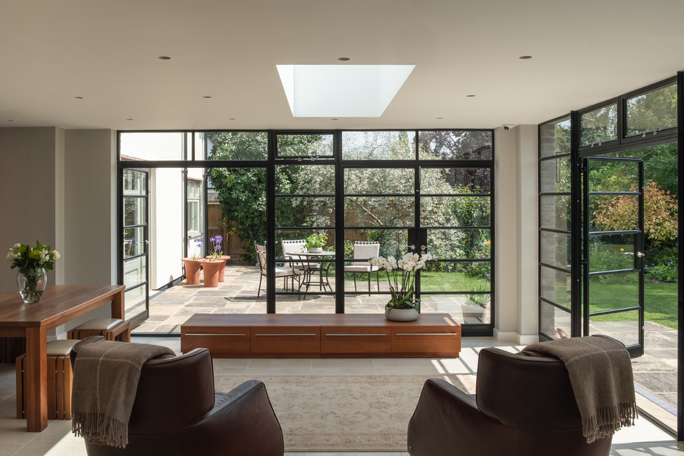 Contemporary living room in Cambridgeshire with beige walls, ceramic floors and beige floor.