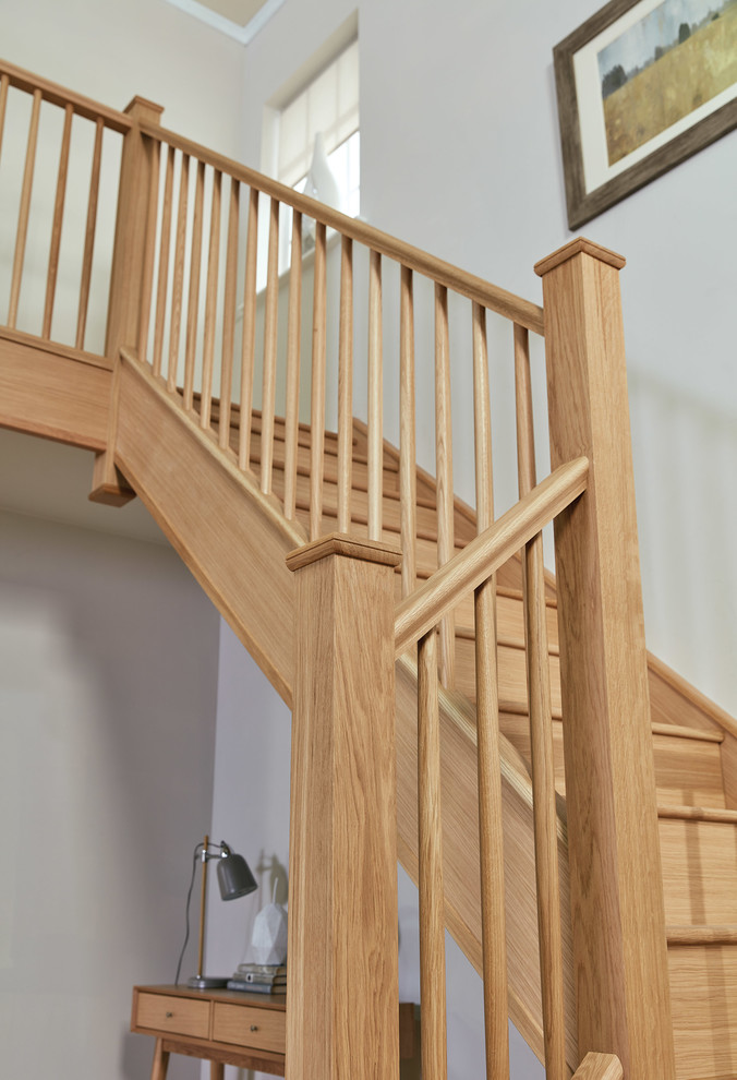 Design ideas for a large contemporary wood u-shaped staircase in Manchester with wood risers and wood railing.