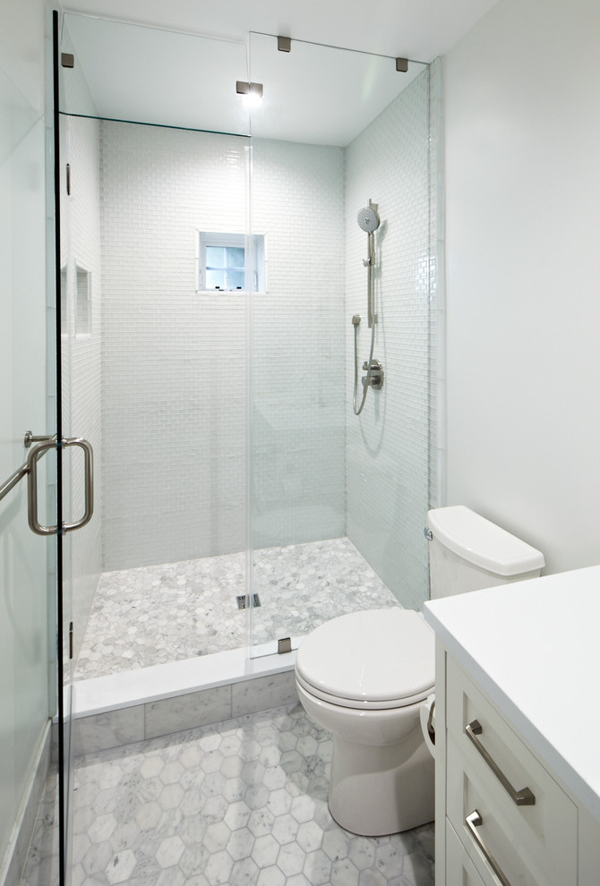 Inspiration for a mid-sized contemporary master bathroom in San Francisco with flat-panel cabinets, white cabinets, solid surface benchtops, beige tile, stone tile, mosaic tile floors, a console sink, an undermount tub, an alcove shower, a one-piece toilet and white walls.