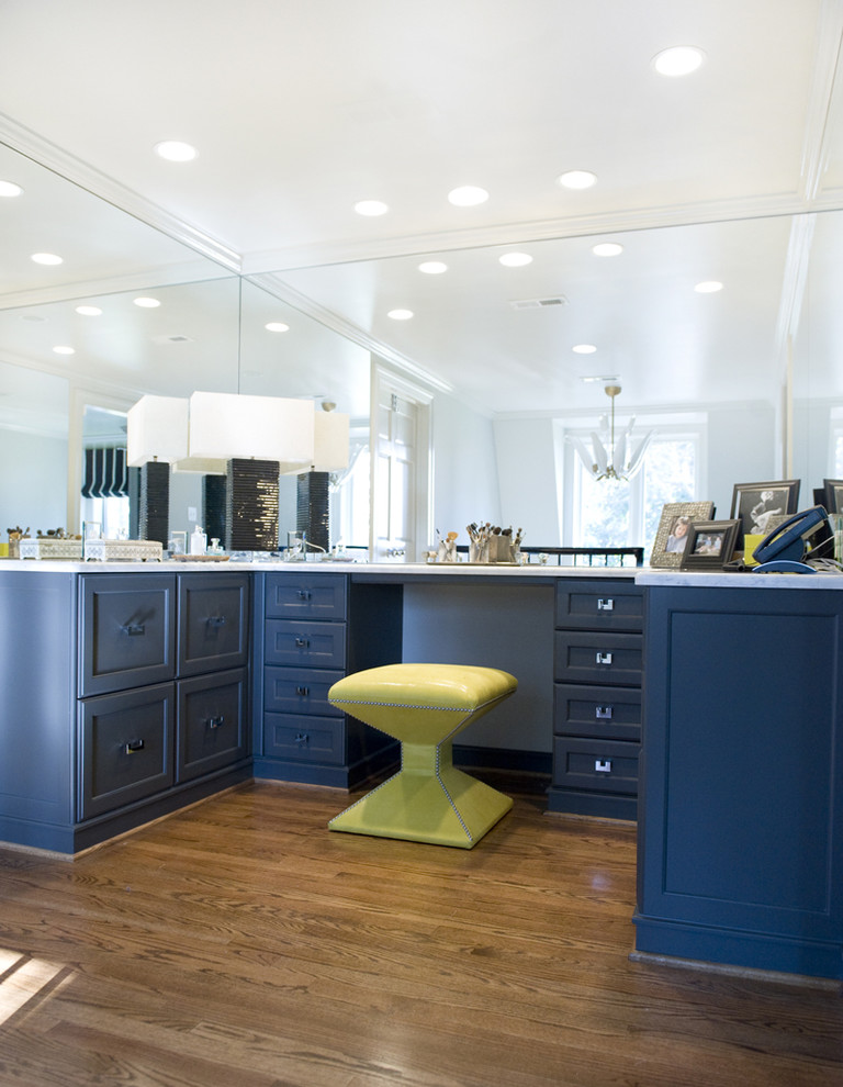 Design ideas for a traditional walk-in wardrobe in Richmond with blue cabinets.
