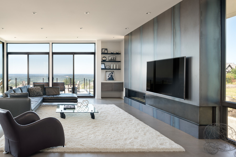 This is an example of a large contemporary open concept family room in Seattle with ceramic floors, a ribbon fireplace, a metal fireplace surround, a wall-mounted tv, multi-coloured walls and grey floor.