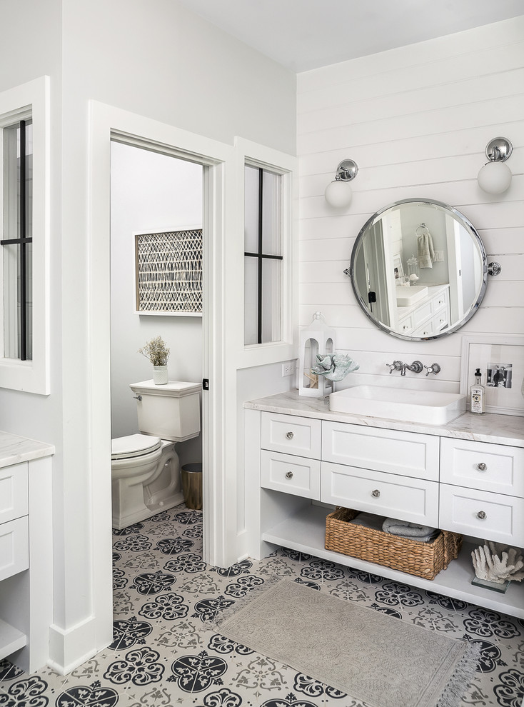 Photo of a country master bathroom in Chicago with shaker cabinets, white cabinets, a two-piece toilet, white walls, cement tiles, a vessel sink, multi-coloured floor, white benchtops and an enclosed toilet.