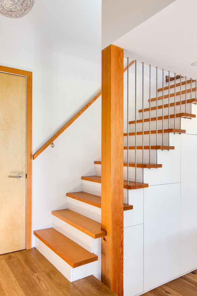 Contemporary wood u-shaped staircase in Vancouver with painted wood risers.