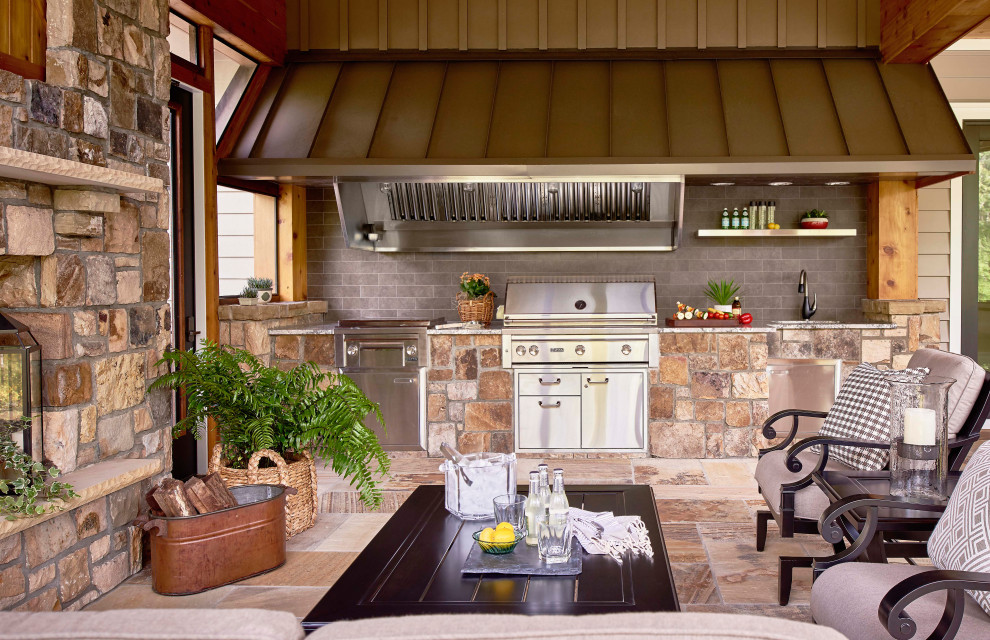 This is an example of a country verandah in Raleigh with an outdoor kitchen.