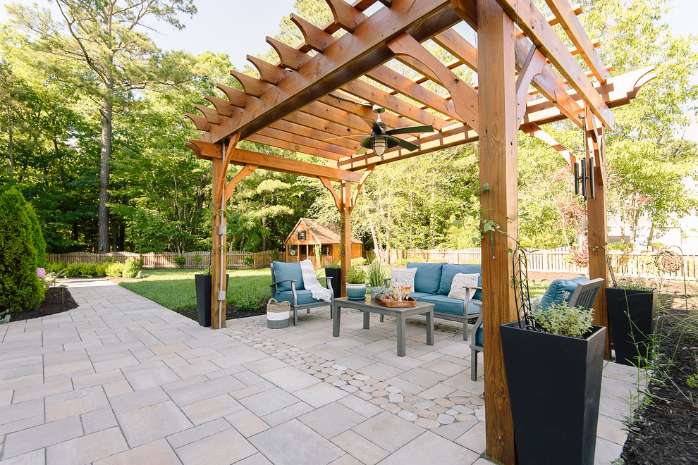 Mid-sized transitional backyard patio in Richmond with a fire feature, concrete pavers and a pergola.
