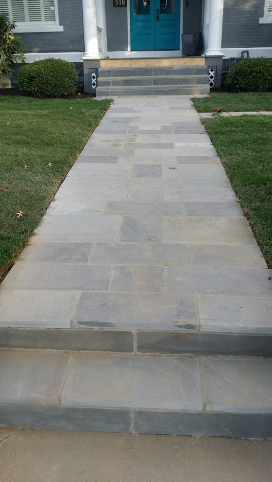 Small modern front yard patio in Other with natural stone pavers and no cover.