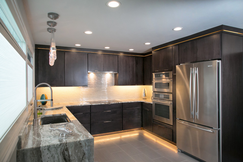 Inspiration for a small modern u-shaped porcelain tile and gray floor enclosed kitchen remodel in Philadelphia with an undermount sink, flat-panel cabinets, dark wood cabinets, quartzite countertops, white backsplash, glass tile backsplash, stainless steel appliances and a peninsula