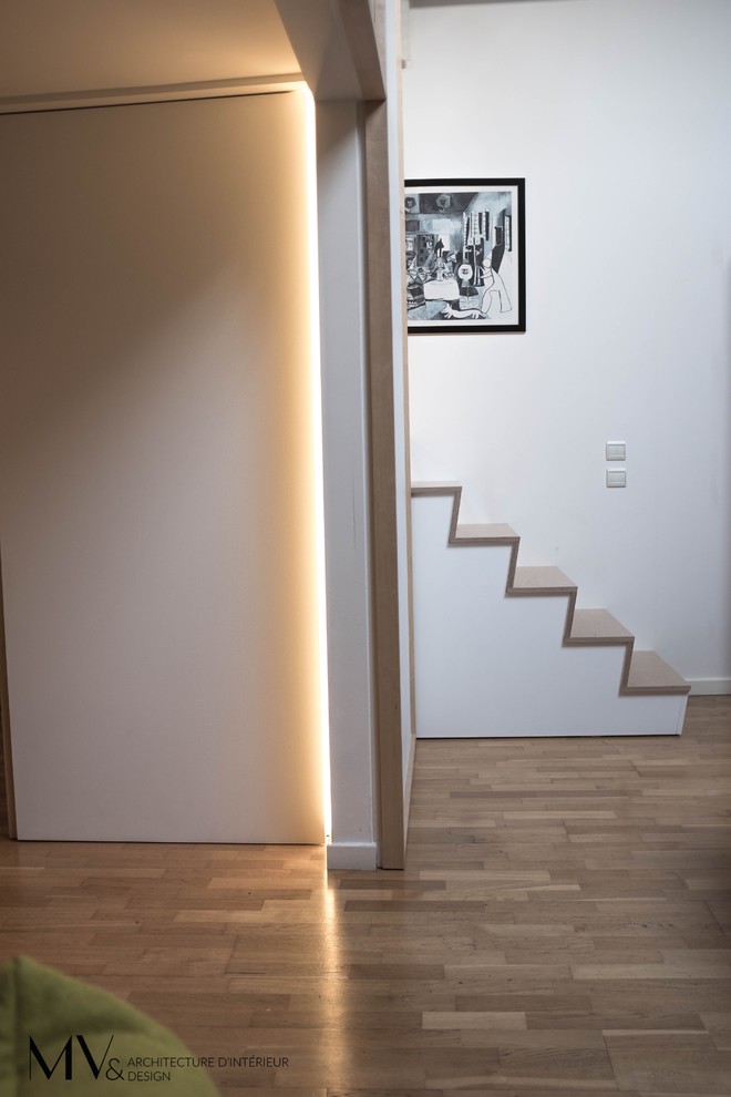 This is an example of a mid-sized contemporary wood straight staircase in Lille with wood risers.