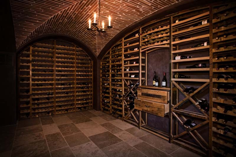 Photo of a mid-sized country wine cellar in Los Angeles with ceramic floors and diamond bins.