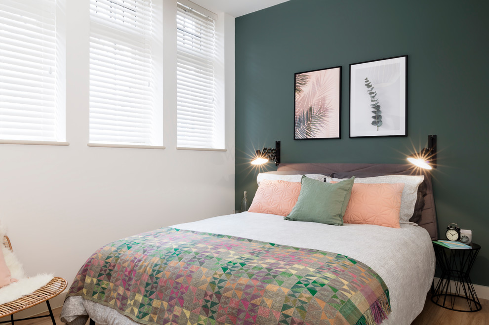 Design ideas for a scandinavian bedroom in Dorset with green walls, vinyl floors and no fireplace.