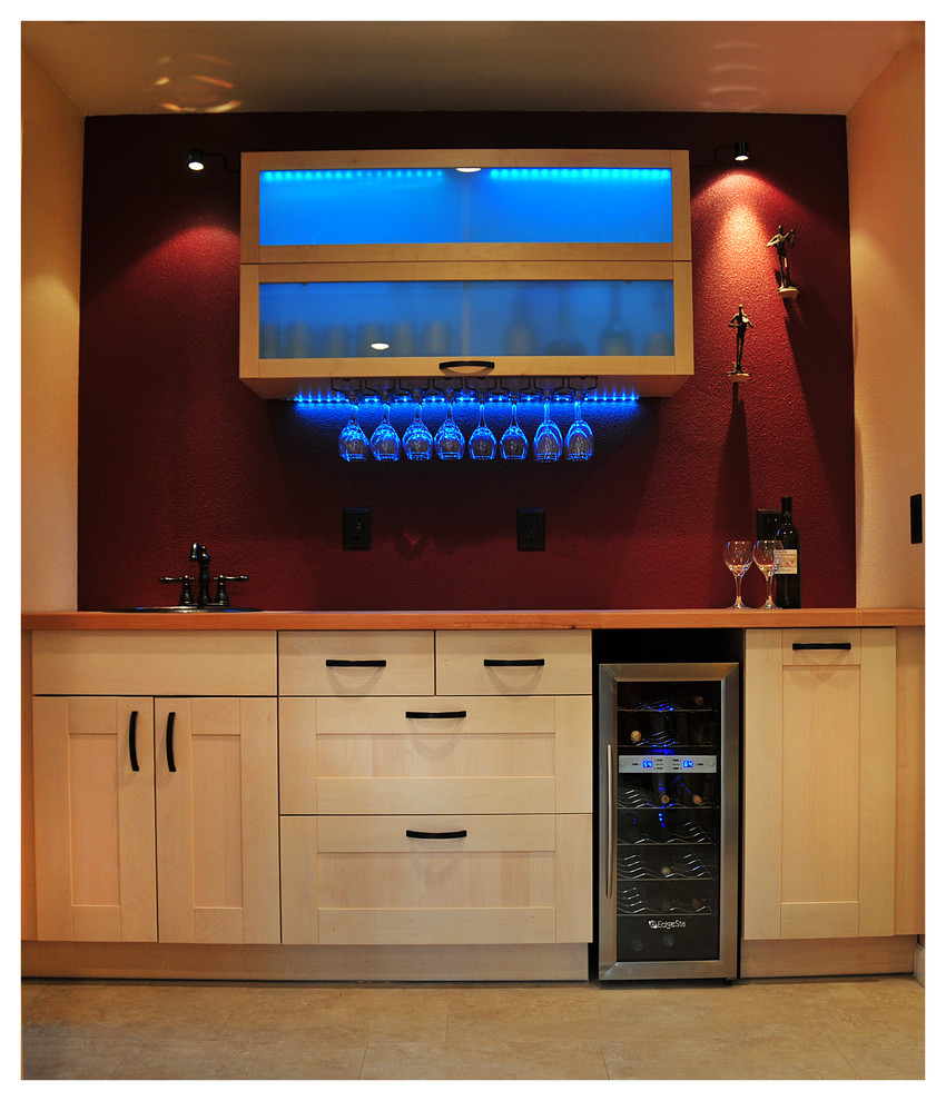 This is an example of a mid-sized contemporary single-wall wet bar in San Francisco with a drop-in sink, shaker cabinets, light wood cabinets, wood benchtops, red splashback and porcelain floors.