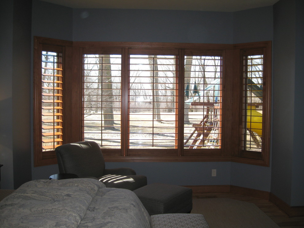 Example of a large transitional master bedroom design with brown walls