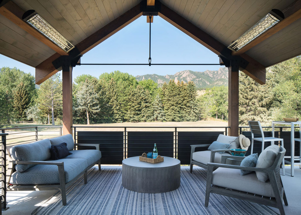 Deck - transitional metal railing deck idea in Denver with a roof extension