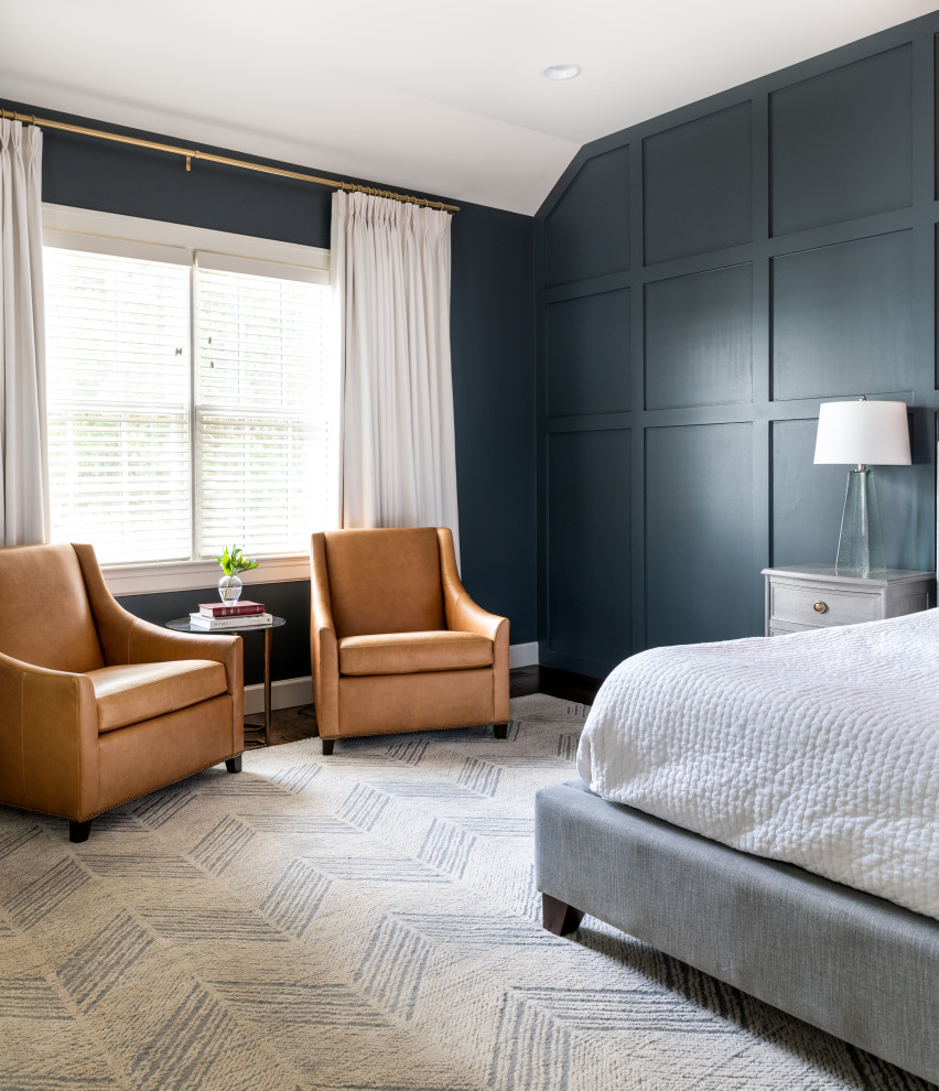 This is an example of a large transitional master bedroom in Nashville with blue walls, dark hardwood floors, brown floor and decorative wall panelling.