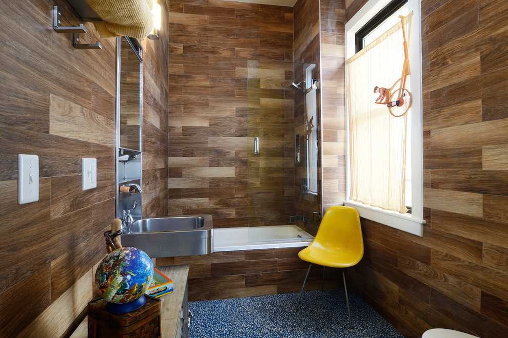 This is an example of a small eclectic bathroom in New York with a wall-mount sink, wood benchtops, an alcove tub and a shower/bathtub combo.