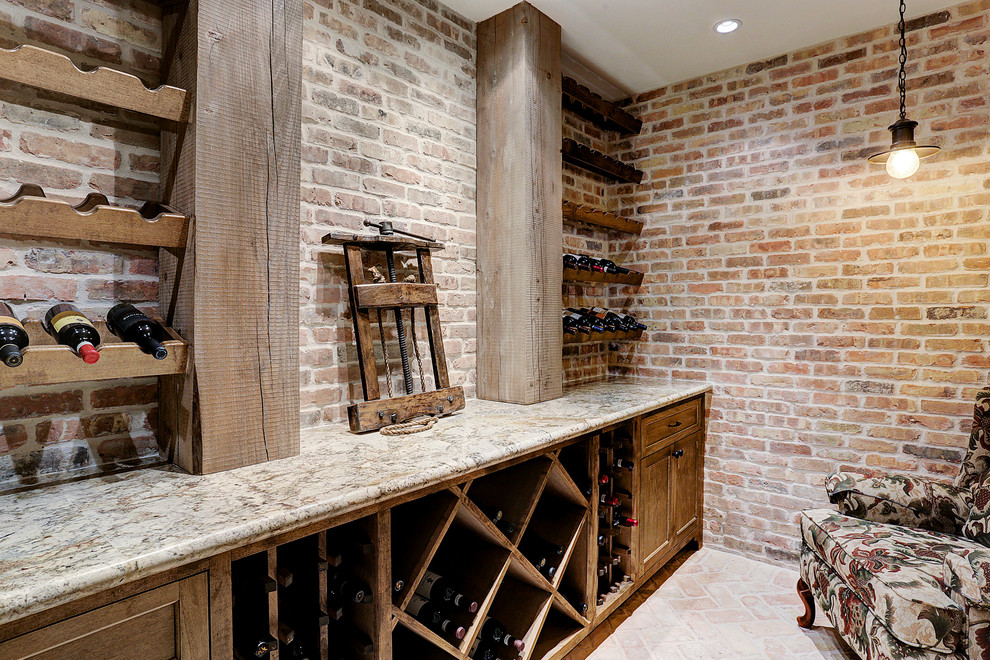 Photo of a large traditional wine cellar in Houston with brick floors and diamond bins.