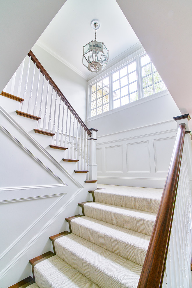 This is an example of a large contemporary l-shaped staircase in Boston with wood railing.