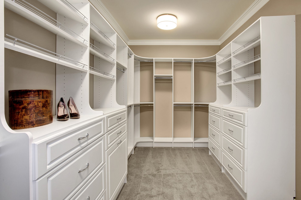 Arts and crafts gender-neutral walk-in wardrobe in Seattle with shaker cabinets, white cabinets and carpet.