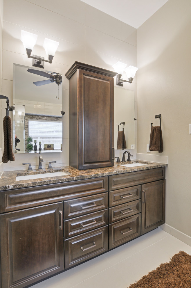 Inspiration for a mid-sized transitional master bathroom in Dallas with raised-panel cabinets, dark wood cabinets, a drop-in tub, a corner shower, beige walls, ceramic floors, an undermount sink and granite benchtops.