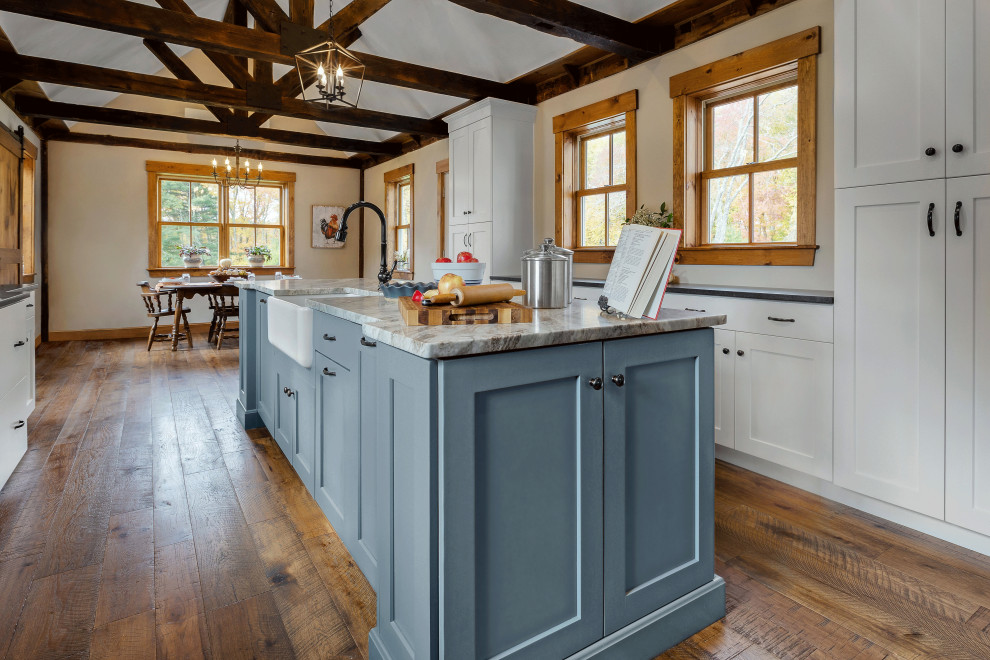Country galley eat-in kitchen in Providence with a farmhouse sink, white cabinets, quartzite benchtops, subway tile splashback, stainless steel appliances and with island.