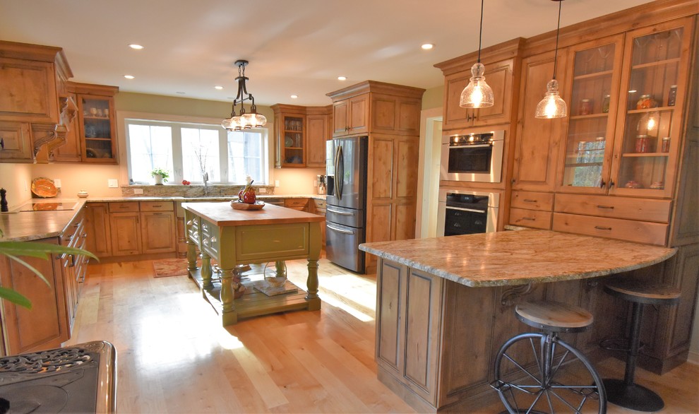 Example of a huge mountain style kitchen design with distressed cabinets