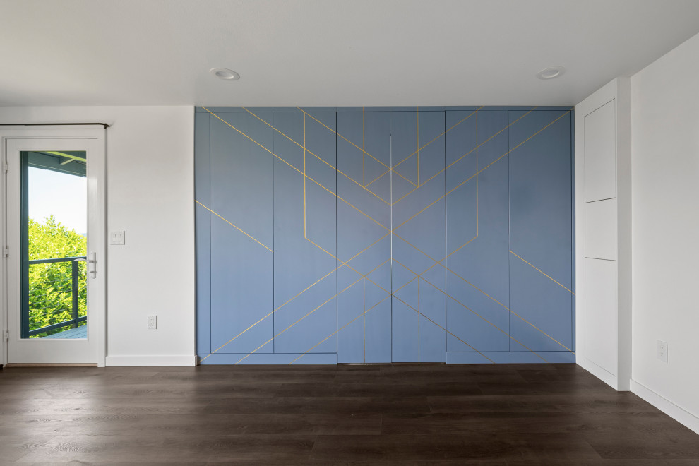 Inspiration for a large transitional single-wall vinyl floor, brown floor and vaulted ceiling open concept kitchen remodel in Seattle with an undermount sink, shaker cabinets, white cabinets, quartz countertops, white backsplash, quartz backsplash, stainless steel appliances, an island and white countertops