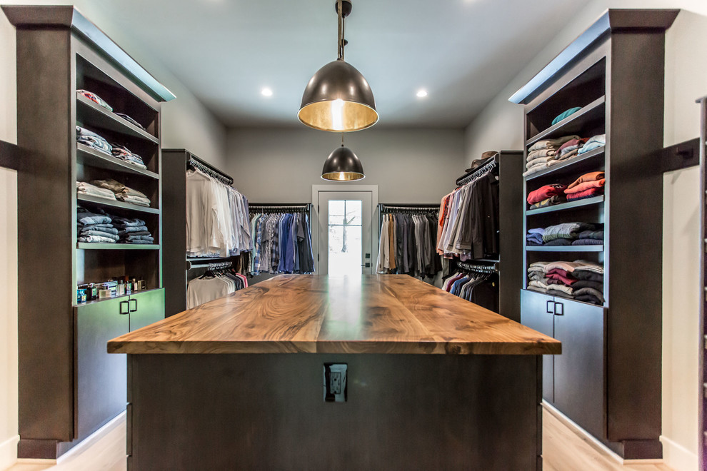 Design ideas for a mid-sized country men's dressing room in DC Metro with flat-panel cabinets, dark wood cabinets, light hardwood floors and beige floor.