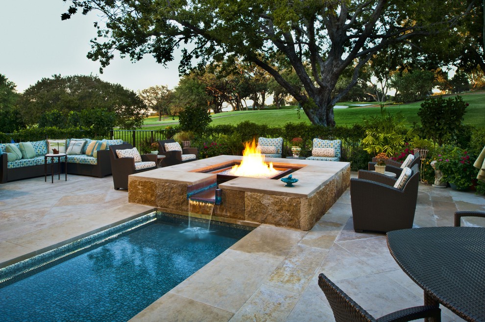 This is an example of a mediterranean backyard rectangular lap pool in Dallas with natural stone pavers.