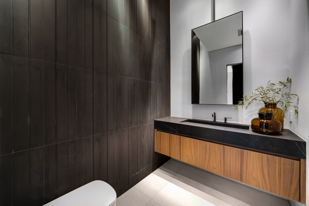 Inspiration for an expansive 3/4 wet room bathroom in Los Angeles with a one-piece toilet, white tile, concrete floors, beige floor, a hinged shower door, black benchtops, a single vanity and a floating vanity.