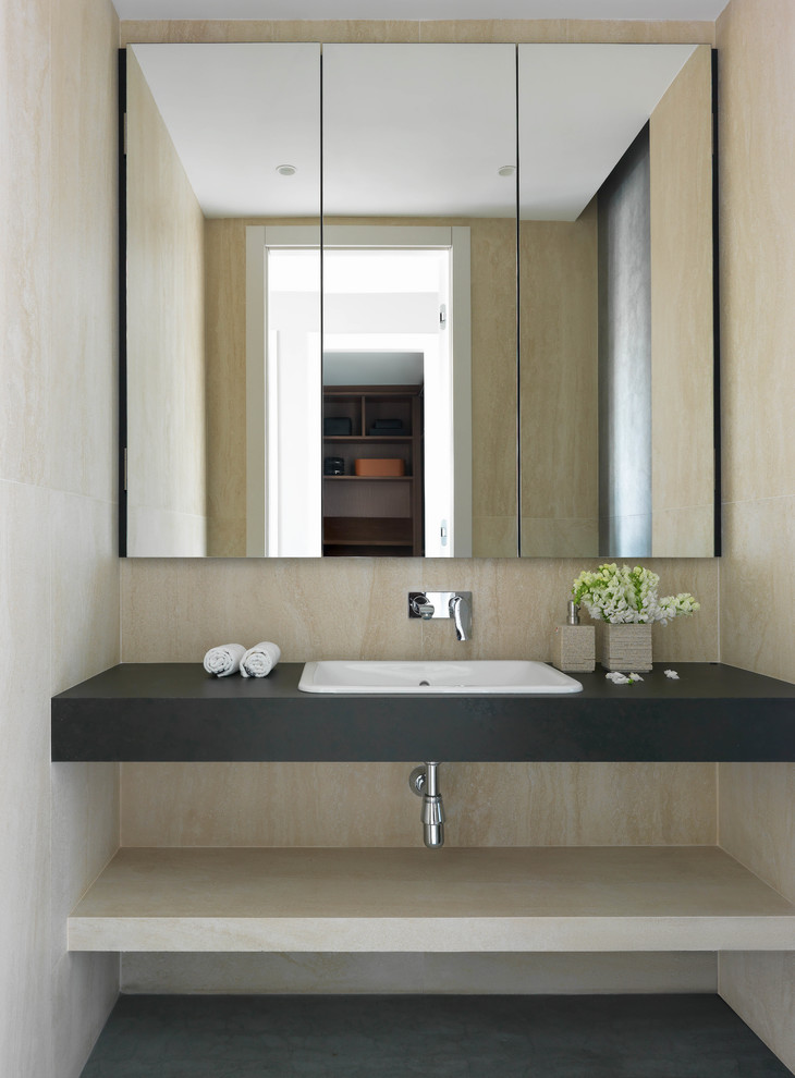 Inspiration for a mid-sized contemporary powder room in Other with beige tile, porcelain tile, porcelain floors, tile benchtops, grey floor, grey benchtops and a drop-in sink.