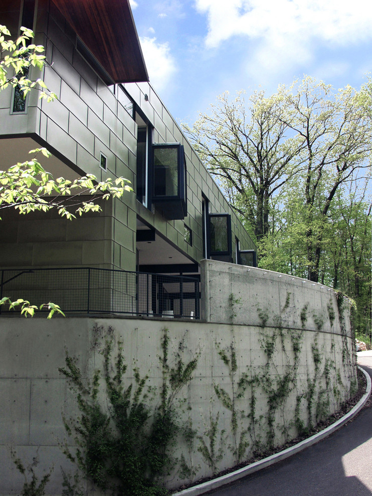 Photo of a large contemporary three-storey grey house exterior in Cincinnati with metal siding and a flat roof.