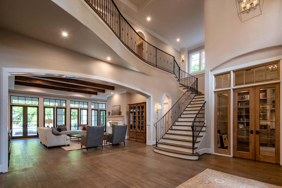 Design ideas for an expansive transitional foyer in Houston with grey walls, dark hardwood floors and brown floor.