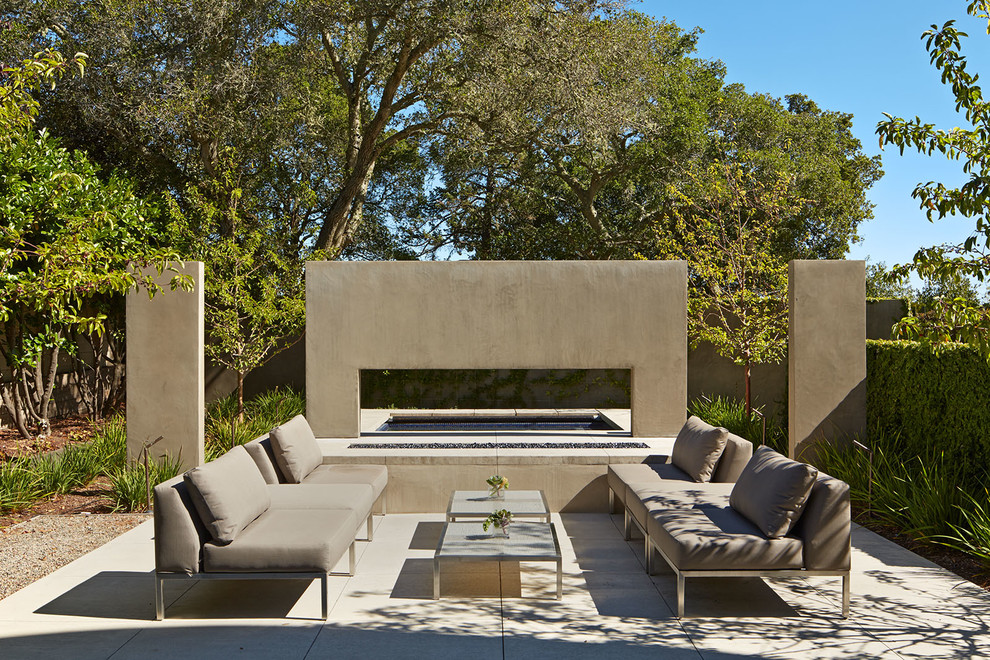 This is an example of a contemporary patio in San Francisco with a water feature and no cover.