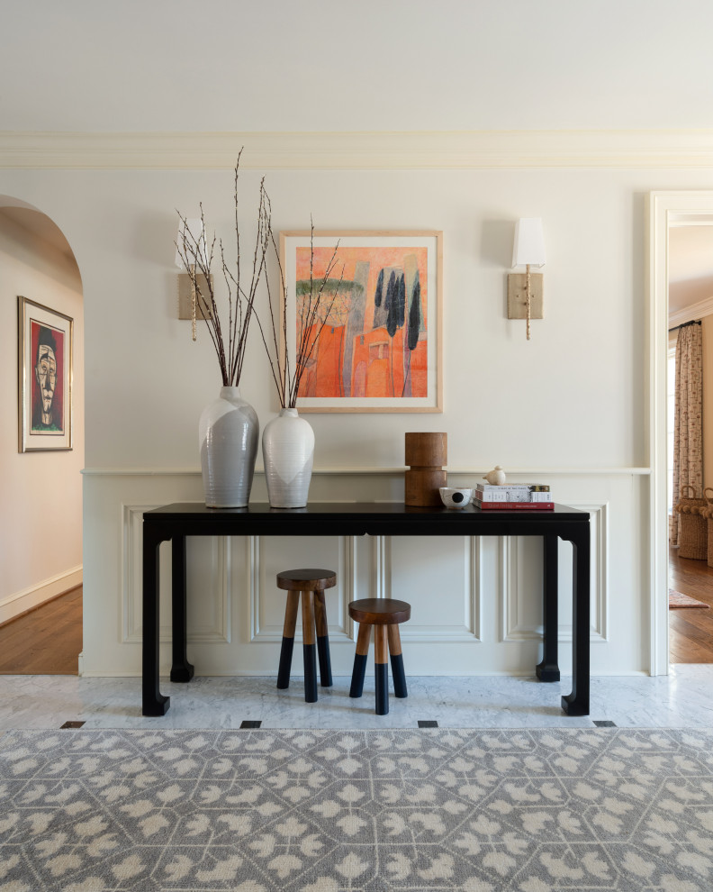 This is an example of a mid-sized traditional foyer in Philadelphia with white walls, marble floors, grey floor and decorative wall panelling.