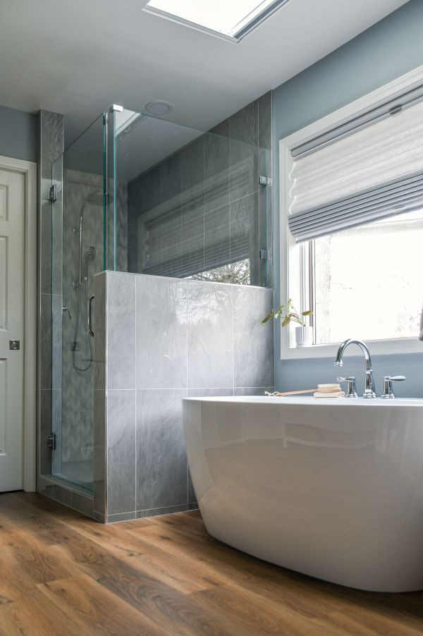 Corner shower - transitional master multicolored tile vinyl floor, brown floor and double-sink corner shower idea with shaker cabinets, white cabinets, blue walls, an undermount sink, quartz countertops, a hinged shower door, white countertops and a built-in vanity