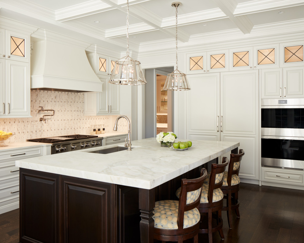 Design ideas for a traditional kitchen in Chicago with an undermount sink, raised-panel cabinets, marble benchtops, white splashback, mosaic tile splashback, stainless steel appliances, dark hardwood floors, with island, brown floor and yellow benchtop.