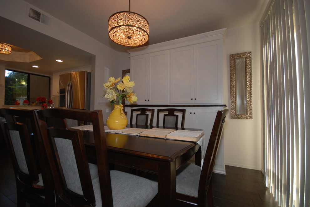 Kitchen/dining room combo - small transitional u-shaped porcelain tile kitchen/dining room combo idea with a farmhouse sink, shaker cabinets, white cabinets, quartz countertops, white backsplash, subway tile backsplash, stainless steel appliances and gray walls