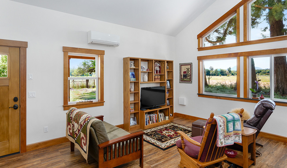 Large mountain style medium tone wood floor, brown floor and vaulted ceiling kitchen photo with a farmhouse sink, raised-panel cabinets, medium tone wood cabinets, concrete countertops, white backsplash, ceramic backsplash, stainless steel appliances, an island and gray countertops