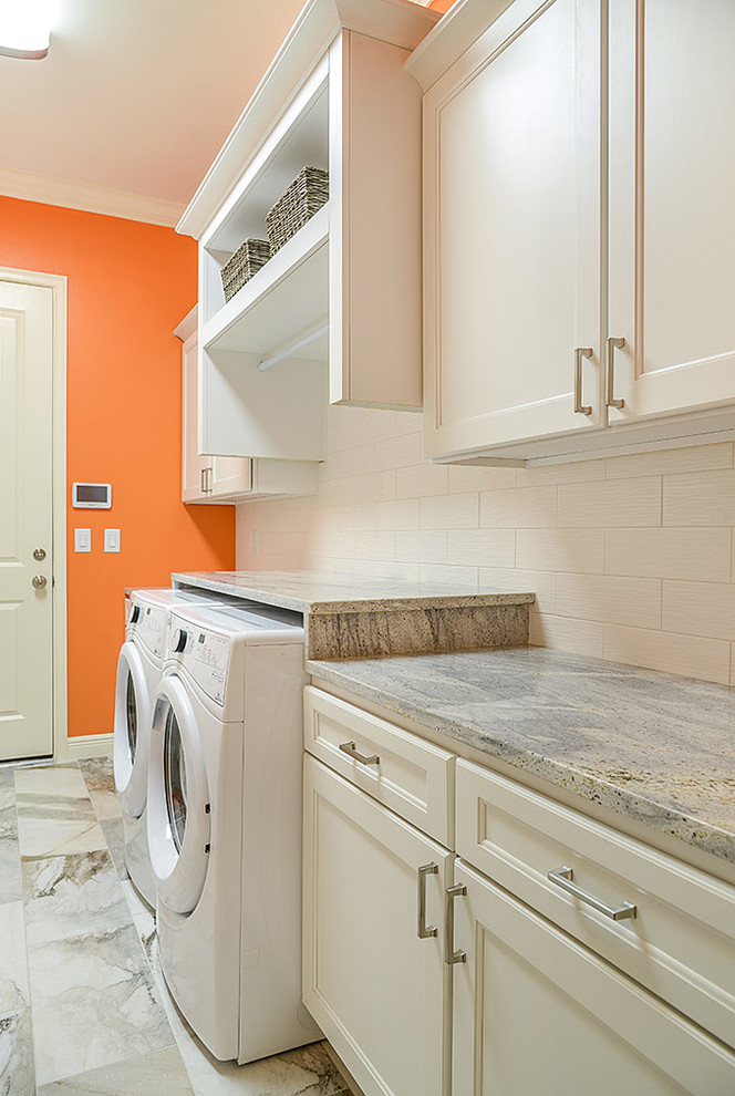 Photo of a large transitional galley utility room in Tampa with an undermount sink, shaker cabinets, white cabinets, granite benchtops, orange walls, porcelain floors and a side-by-side washer and dryer.