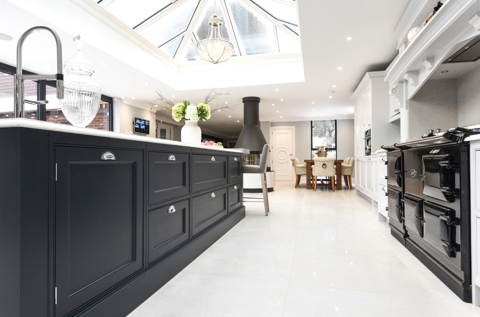 This is an example of a large traditional l-shaped eat-in kitchen in Berkshire with a drop-in sink, shaker cabinets, grey cabinets, quartzite benchtops, grey splashback, mirror splashback, panelled appliances and with island.