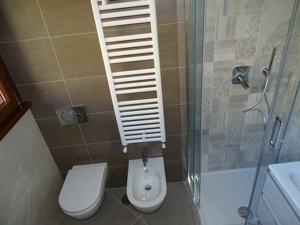 Small contemporary bathroom in Rome with flat-panel cabinets, a two-piece toilet, porcelain tile, porcelain floors, an integrated sink and quartzite benchtops.
