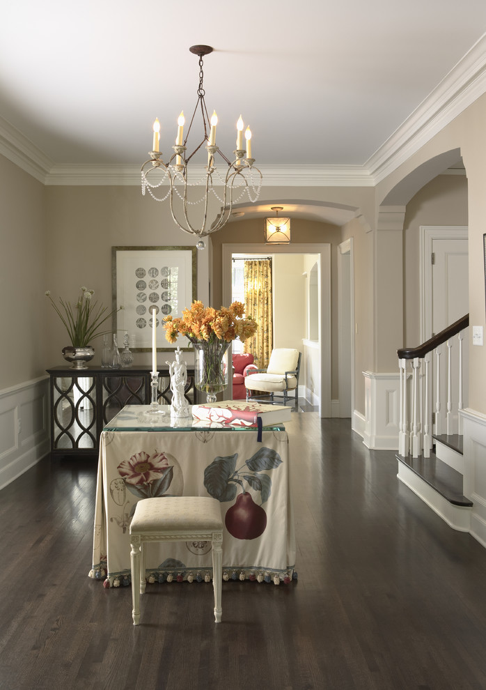 Inspiration for a traditional foyer in Minneapolis with beige walls and dark hardwood floors.